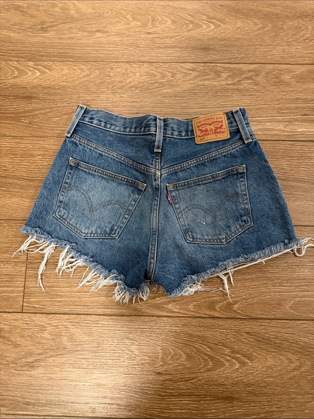 Levi's Distressed Raw-Hem Denim Shorts in Mid Blue